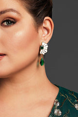 Curveins Elegant Floral Oval Drop Earrings featuring a white enamel flower design with a vibrant green teardrop gemstone, perfect for formal occasions.