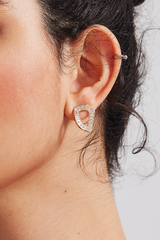 Close-up of Teardrop Crystal Stud Earrings with gold-tone base and crystal accents on an ear.