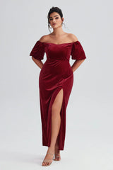  Plus size woman wearing a champagne-colored strapless satin gown with a ruffled high-low hem, perfect for formal events or special occasions.