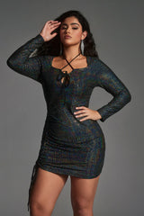 Plus size woman wearing a sparkly black bodycon mini dress with criss-cross back straps, perfect for parties or night out events.