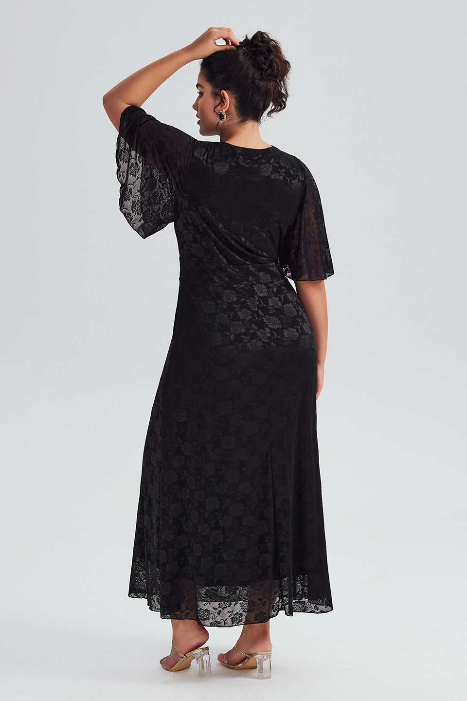 Back view of plus-size black lace maxi dress, highlighting the lace detailing and flowing maxi length, ideal for formal events