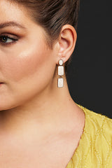 Close-up of square enamel drop earrings featuring three glossy enamel squares set in a gold-tone frame, perfect for formal or casual occasions.