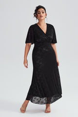 Full-length view of plus-size black lace maxi dress with flutter sleeves, showing a flattering fit for special occasions