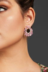 Close-up of chic pink crystal waterdrop earrings with an open hoop design, set in a gold-tone frame, featuring dazzling pink crystals.